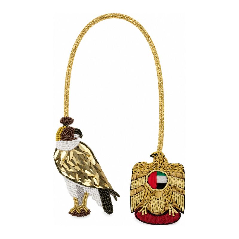 Necklace with a beaded falcon charm and a gold UAE emblem charm